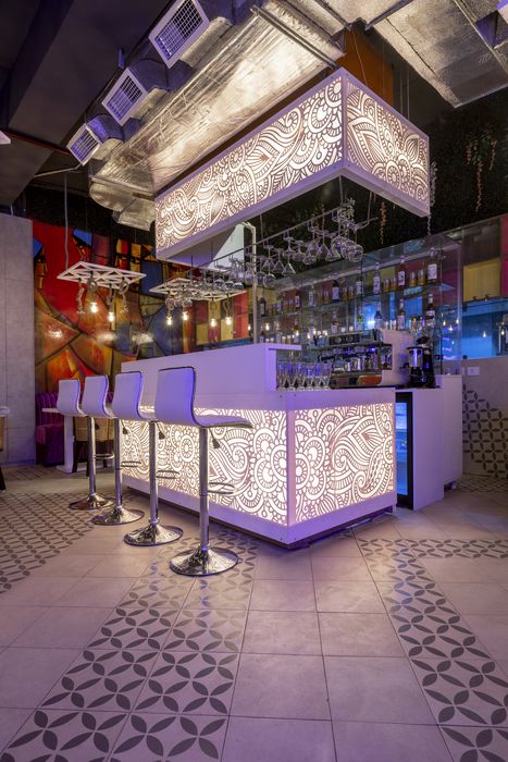 A patterned, illuminated bar interior photographed by Capturekraft